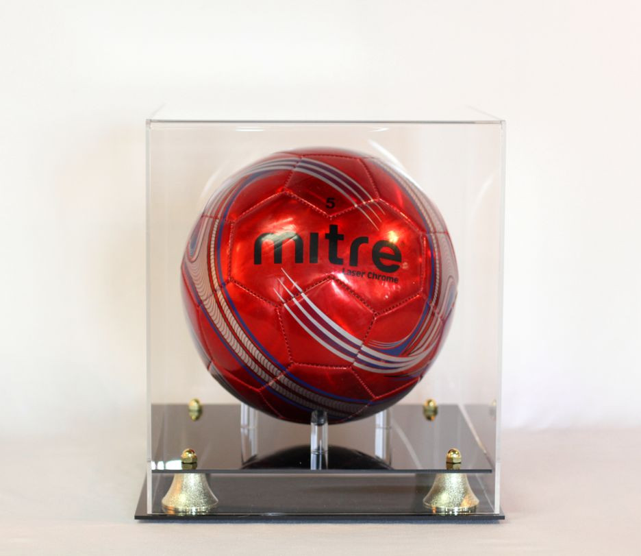 Soccer ball display case acrylic with two-tier black base. Gold corner risers
