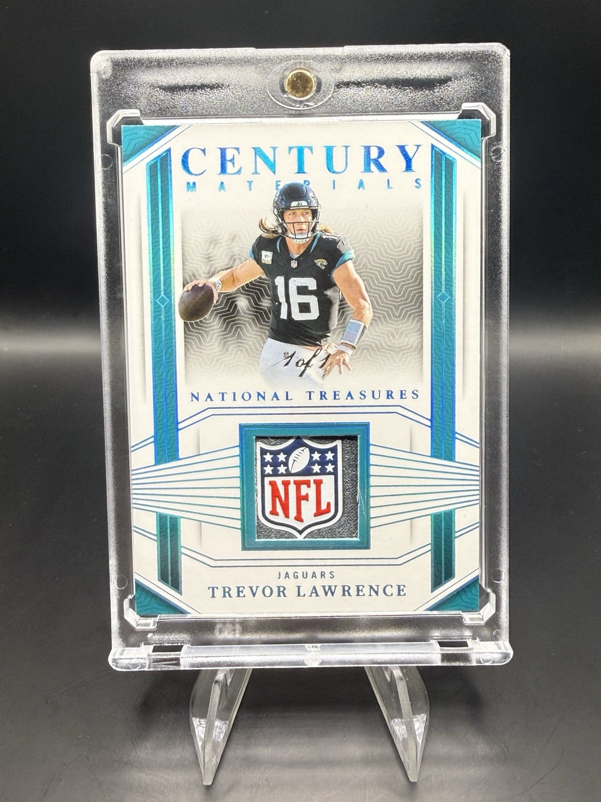 2023 National Treasures- Century Materials Trevor Lawrence NFL Shield /1 Jaguars