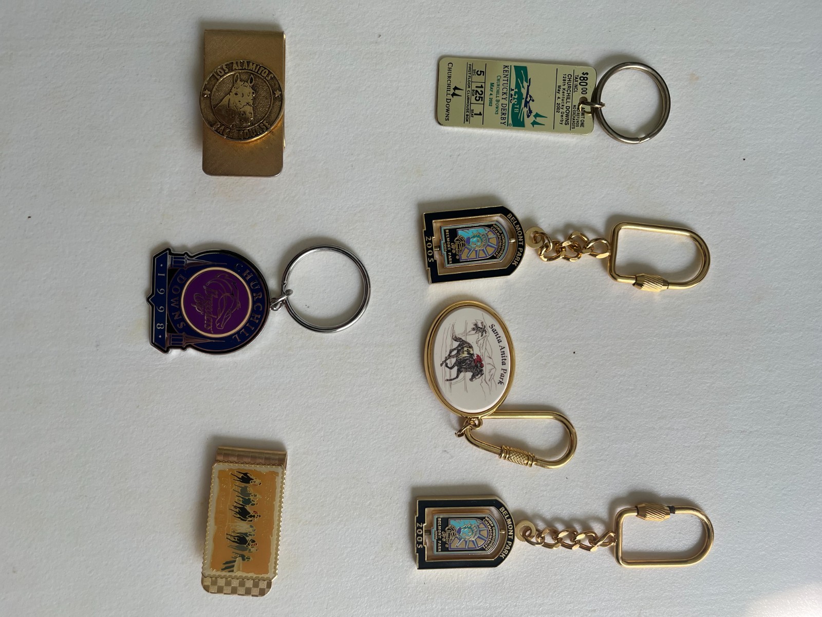 Various horse racing track key rings and money clips