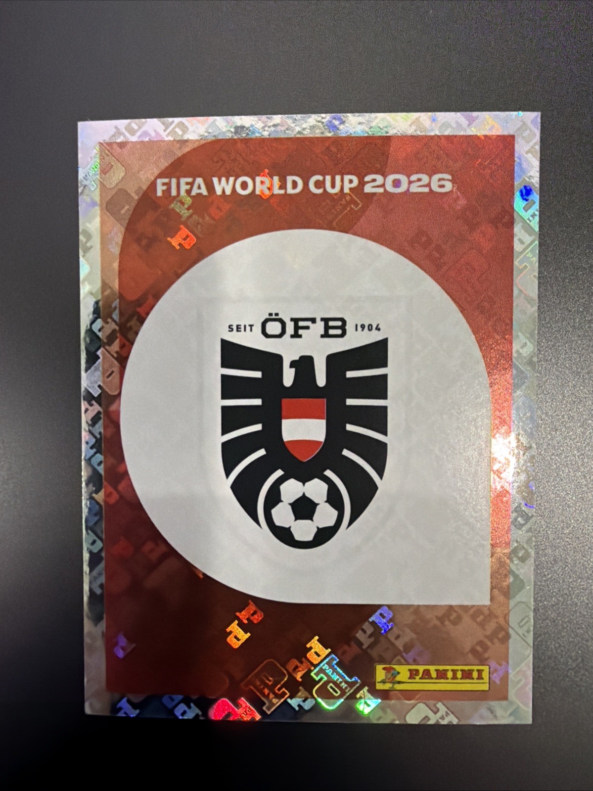 2026 FIFA World Cup Panini Sticker Austria Team Logo Foil AUT 1