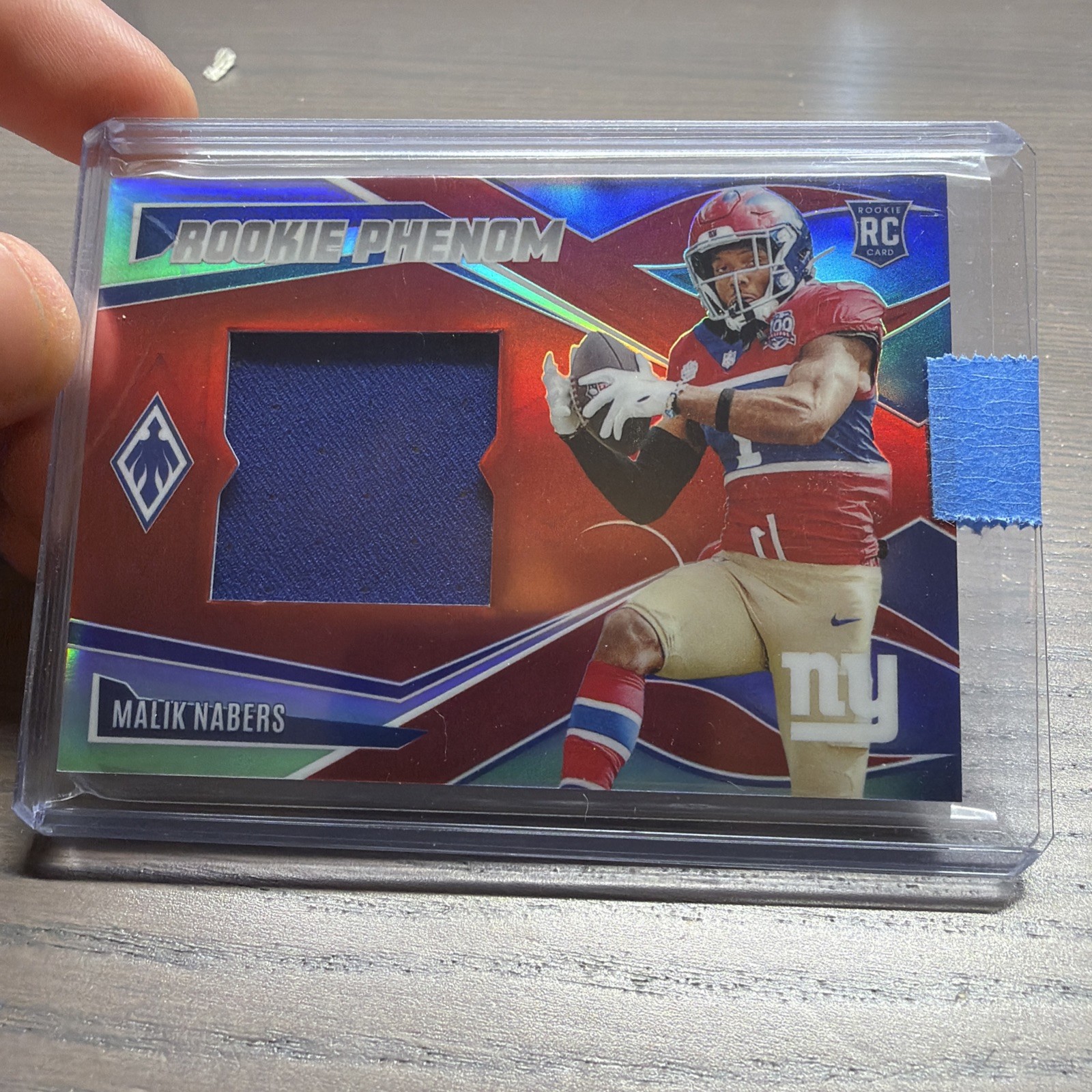 2024 Panini Phoenix – Rookie Phenom Jersey Malik Nabers Red /99 (MEM, RC)
